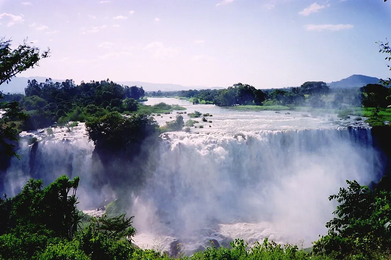 The Blue Nile Falls flowing over a green escarpment in Ethiopia